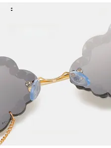 Macro view of cloud-shaped sunglasses featuring comfortable blue nose pads and gold metal bridge