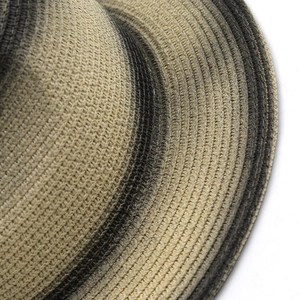 Macro view of detailed straw weaving and gradient color pattern on a sun hat