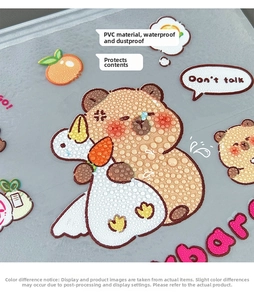 Detail showing waterproof PVC pencil case with cute capybara print and clear water droplets