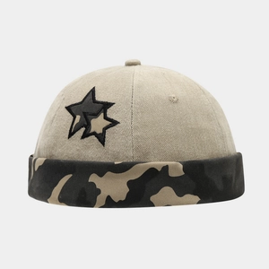 Detail of docker hat with beige twill fabric camouflage brim and star embroidery
