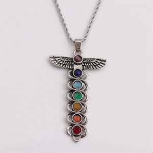 Silver caduceus pendant necklace with seven colorful chakra stones on white background