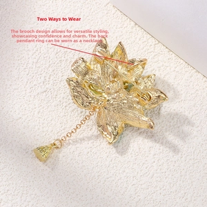 Detail of gold enamel peony brooch back showing dual-purpose pin and pendant loop