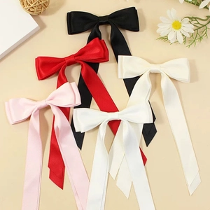 Satin double bow hair clips with long streamers in five elegant colors on light background