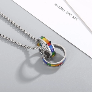 Macro shot of interlocking double rings with vibrant rainbow enamel on a silver chain