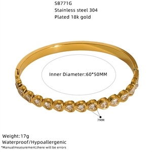 Detailed view of gold heart bangle in 304 stainless steel with 18k gold plating