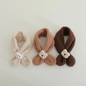 Detail of knitted baby scarves featuring plush rabbit and cartoon bear ornaments