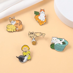 Close-up of creative cat enamel pins including orange cat and yellow raincoat cat designs