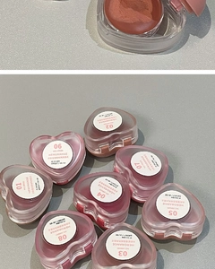 Detailed view of heart-shaped lip and cheek mud containers in eight matte shades
