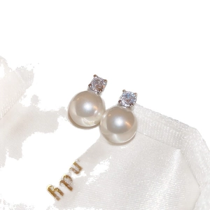 Vintage style stud earrings featuring white round pearls and sparkling zircon stones