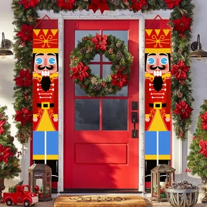Detail of Nutcracker soldier Christmas porch banners with wreaths on red doors