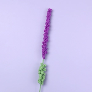 Handmade knitted lavender flower bouquet in purple wool yarn on a minimal background
