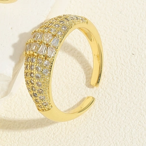 Macro shot of gold geometric open ring with micro-paved cubic zirconia crystals