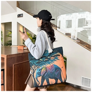 Detail shot of canvas tote featuring elephant jacquard patterns and cotton rope handles