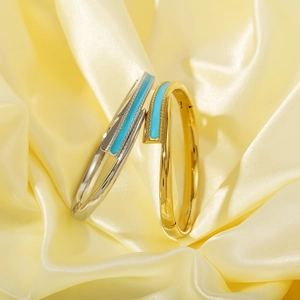 Minimalist 18K gold and silver plated bangles with blue enamel inlay on yellow silk fabric