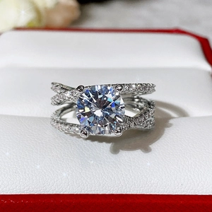 Macro shot of silver classic four-prong zircon ring with crisscross pavé band detail