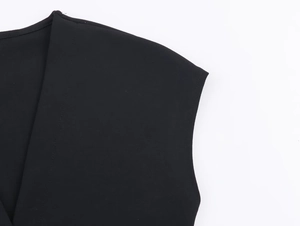 Detail view of V-neckline and fine stitching on a black sleeveless midi dress