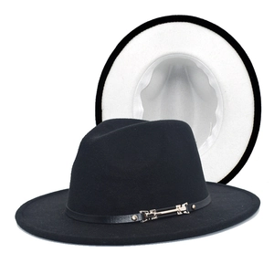 Detailed macro view of the two-tone wool fedora with a black leather band and gold buckle