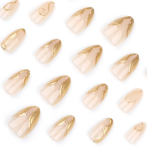 3D gold irregular almond fake nails with nude base and metallic gold wave pattern art