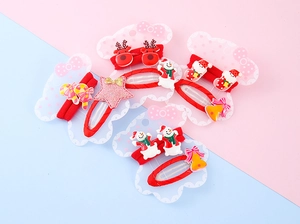 Detailed view of Christmas hair clips and ties with reindeer, snowman and Santa motifs