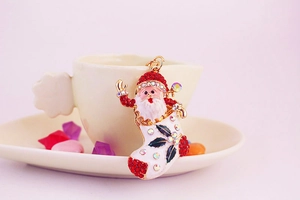 Detailed close-up of a sparkling Christmas Santa boot keychain with red rhinestones