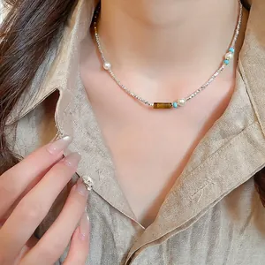 Tiger eye and pearl beaded necklace on model with vintage ethnic style choker design