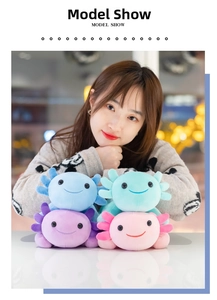 Smiling plush axolotls in blue, pink, and purple held by a model in a cozy indoor setting
