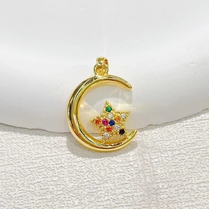 Gold plated moon and star pendant with colorful cubic zirconia inlays on white marble