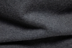 Macro shot of dark grey knit fabric showing high-quality fine texture and soft fibers