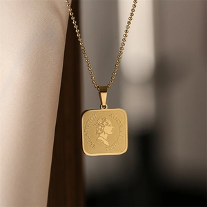 Close-up of gold titanium steel coin pendant with Queen Elizabeth portrait and ball chain