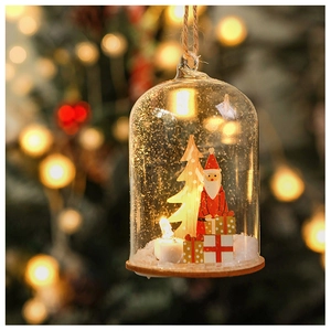 Close-up of LED glowing glass dome ornament with Santa and a rustic wooden base
