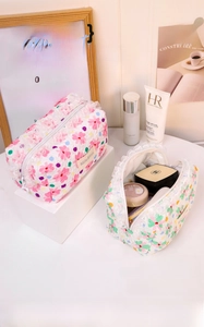 Detail view of floral seersucker makeup bags with lace trim and large storage capacity