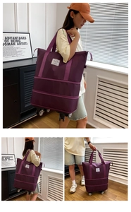 Purple expandable travel bag with wheels showing shoulder strap and rolling base