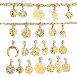 Detailed close-up of gold celestial charms including sun, moon, and stars with lobster clasp