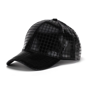 Detail view of black PU leather baseball cap with unique square embossed texture and glossy finish