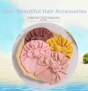 Detailed texture of baby turban hats with bow knots in four soft pastel colors