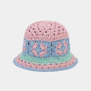 Close-up of crochet hollow flower patterns on a colorful knit bucket hat for women