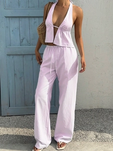 Detail of pink and white striped halter v-neck crop top and trousers for summer vacation