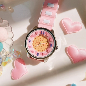 Detailed close-up of pink silicone watch strap and Biscuit dial with heart accents