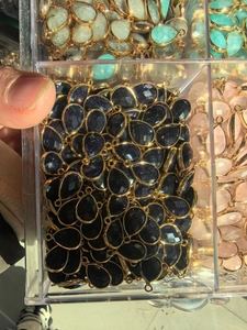 Macro shot of blue sandstone teardrop pendant with gold plating for DIY jewelry making