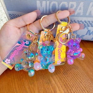 Three gradient crystal heart bear keychains with faceted textures and laser PVC hand straps