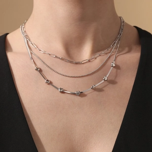 Three-layer silver necklace with paperclip chain, bead chain and heart snake chain