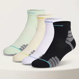 Elite mid-cut basketball socks with thick cushioning in black, white, and mint colors