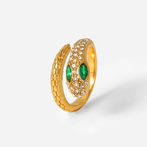 Detailed view of a gold snake ring with green stone eyes and white cubic zirconia stones