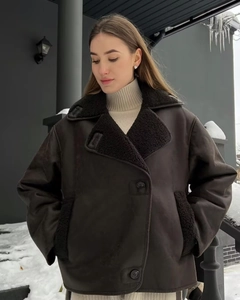 Detailed close-up of dark brown faux leather jacket with black faux shearling lapels