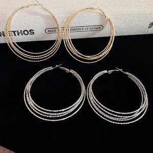 Fashionable multi-layer hoop earrings in gold and silver finish with textured surface