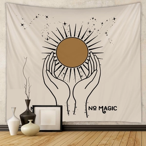 Detail of bohemian sun and moon tapestry with 'NO MAGIC' text in a minimalist room