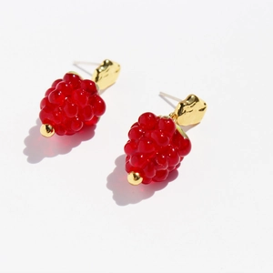 Fresh red glass raspberry fruit earrings with gold finish and silver needles on white background