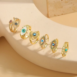 Detail of adjustable evil eye rings in gold finish with colorful zircon and enamel inlay