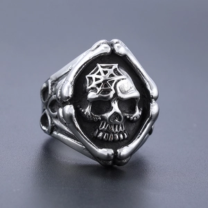 Macro shot of gothic grim reaper skull ring with spider web engraving on steel