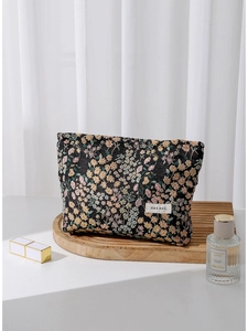 Floral jacquard travel makeup bag with large capacity displayed on a wooden tray